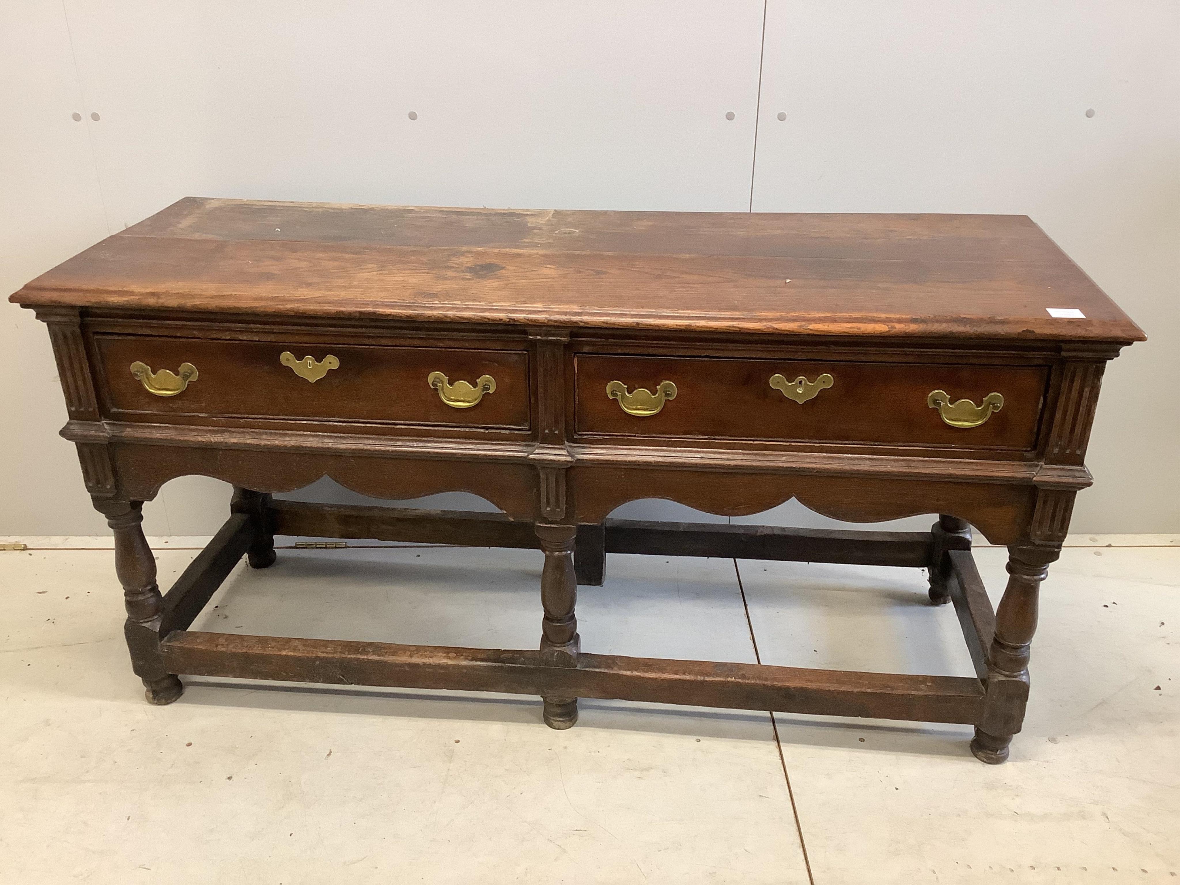 An 18th century oak low dresser base with two long drawers, width 150cm, depth 53cm, height 77cm. Condition - fair